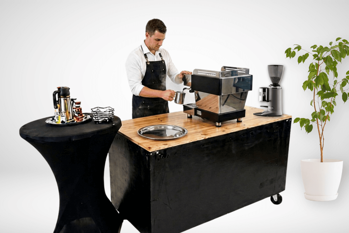 Barista steaming milk at a mobile coffee cart in Beachwood